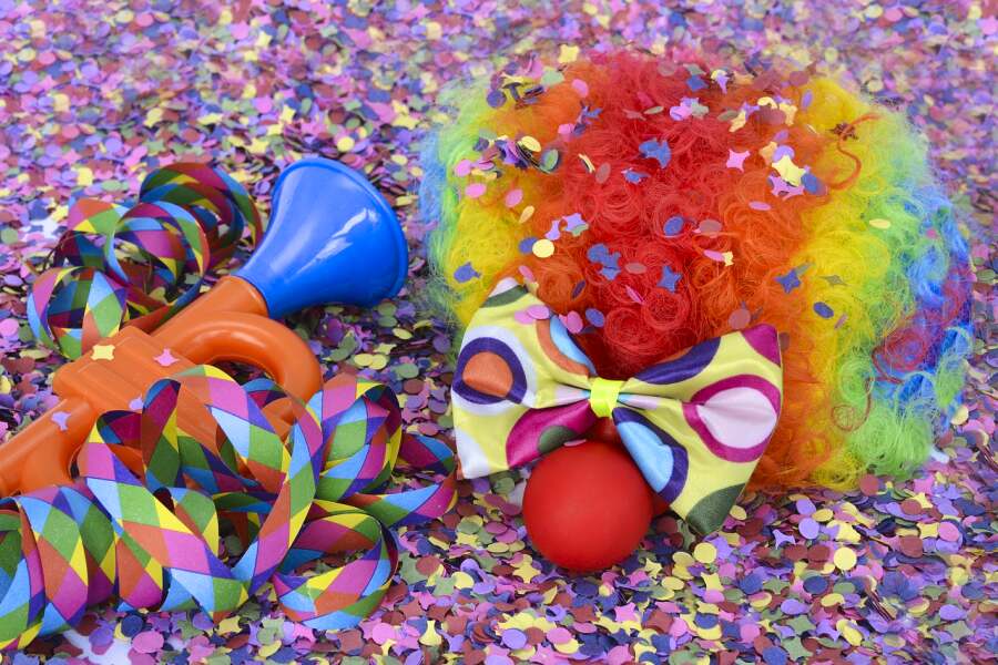 Karnevalsperücke und Pappnase auf Konfetti